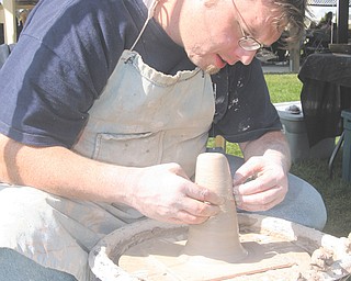 Christopher Karg of Brookfield crafts a piece of pottery Sunday at the Oktoberfestival in Boardman Park. The event is sponsored by the Boardman Rotary Club. This was the 36th annual event and the first with a slight name change from Oktoberfest.