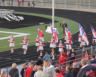 Rifle and flag lines at attention while the homecoming king and queen are announced