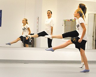 Holly Podbesek works with D’Ella Heschmeyer, 12, of Liberty on her Irish dance moves. Podbesek, who has been performing and teaching Irish dance for more than 30 years, recently purchased Northeast Martial Arts Dance and Fitness in Austintown and added the Sheridan Academy of Irish Dance to the schedule.