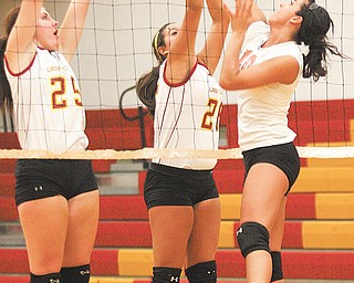 Howland’s Megan Papalas tries to get a shot past Cardinal Mooney’s Nichole Webber (25) and Lorena Cancel on Monday in the Cardinals’ gym.