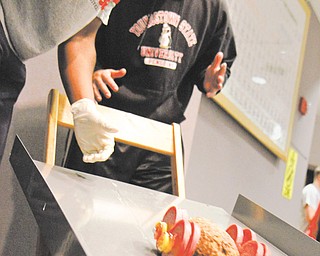 Willie Champman and Chris Mikut launch their  edible meat car down the ramp. It just about made the 6 inch mark, which met the requirement for the assignment. 