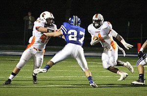 NICK MAYS l THE VINDICATOR (4) De'Veon Smith looks to follow the blocking of (41) Ralph Robinson as (27) Anthony Kosec comes up to try for the tackle during thier game Friday night in Poland. howland vs poland 10052012 Poland, Ohio