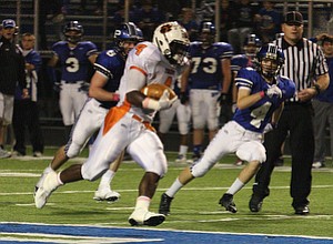 NICK MAYS l THE VINDICATOR (4) De'Veon Smith tales off down field for a long gain past (4) Dave Morocco of Poland during thier game Friday night in Poland. howland vs poland 10052012 Poland, Ohio