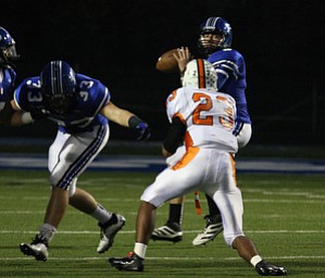 NICK MAYS l THE VINDICATOR (5) Jacob Wolfe of Poland looks down field as (23) T.K. Fortson tries to make a play during thier game Friday night in Poland. howland vs poland 10052012 Poland, Ohio