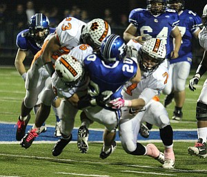 NICK MAYS l THE VINDICATOR (20) Ross Gould of Poland is tackled by (23) T.K. Fortson, (7) Chris Maze and Trey Bryarly of Howland during thier game Friday night in Poland. howland vs poland 10052012 Poland, Ohio
