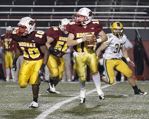 ROBERT K. YOSAY | THE VINDICATOR..Following his blocker #10 Justus Ellis-Moore #16 Jon Saadey looks downfield - ..Lakewood St Edwards vs Cardinal Mooney at Stambaugh Stadium at YSU -... - -30-..