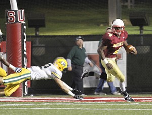 ROBERT K. YOSAY | THE VINDICATOR..Mooneys #4 Marcu McWIlson looks for an opening after eluding St Ed's #22 - .Lakewood St Edwards vs Cardinal Mooney at Stambaugh Stadium at YSU -... - -30-..