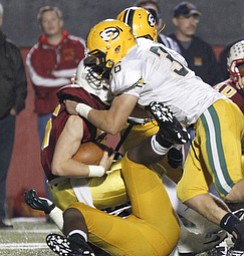 ROBERT K. YOSAY | THE VINDICATOR..Mooneys QB Jon Saadey is sacked by #36 Ryan Davis - during first quarter action - ..Lakewood St Edwards vs Cardinal Mooney at Stambaugh Stadium at YSU -... - -30-..