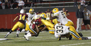            ROBERT K. YOSAY  | THE VINDICATOR..Mooneys #10  fights for a first down during second quarter action as three St Eds players - ...Lakewood St Edwards vs Cardinal Mooney at Stambaugh Stadium at YSU -... - -30-..