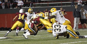 ROBERT K. YOSAY | THE VINDICATOR..Mooneys #10 fights for a first down during second quarter action as three St Eds players - ...Lakewood St Edwards vs Cardinal Mooney at Stambaugh Stadium at YSU -... - -30-..