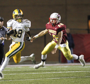            ROBERT K. YOSAY  | THE VINDICATOR..St eds #19  bolts out tof the backfield  and saunters for a first down as Mooneys #15  Denver Martin  is left behind -.Lakewood St Edwards vs Cardinal Mooney at Stambaugh Stadium at YSU -... - -30-..