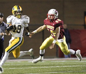 ROBERT K. YOSAY | THE VINDICATOR..St eds #19 bolts out tof the backfield and saunters for a first down as Mooneys #15 Denver Martin is left behind -.Lakewood St Edwards vs Cardinal Mooney at Stambaugh Stadium at YSU -... - -30-..