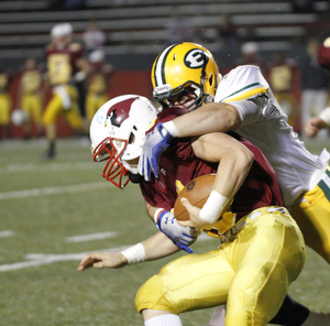            ROBERT K. YOSAY  | THE VINDICATOR.. Mooneys Jon Saadey is tied up at the line by..Lakewood St Edwards vs Cardinal Mooney at Stambaugh Stadium at YSU -... - -30-..