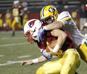 ROBERT K. YOSAY | THE VINDICATOR.. Mooneys Jon Saadey is tied up at the line by..Lakewood St Edwards vs Cardinal Mooney at Stambaugh Stadium at YSU -... - -30-..
