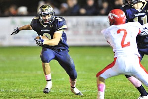 Brookfield running back #3 Ryan Mosora runs the ball down the sideline on the option play.