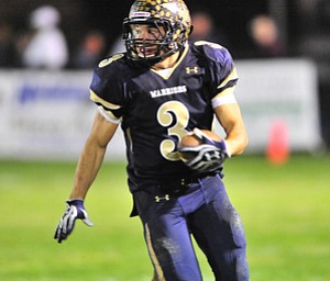 Brookfield running back #3 Ryan Mosora runs the ball down the sideline on the option play.