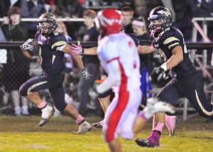 Brookfield running back #3 Ryan Mosora runs the ball down the sideline after making it into the open field on the running play.option play.