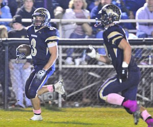 Brookfield running back #3 Ryan Mosora runs the ball down the sideline after making it into the open field on the running play.option play.
