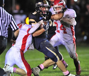 Brookfield running back #3 Ryan Mosora tries to spin out ogf the would be Edgewood tacklers #7 Shawn Hodge and #24 Josh Vass.