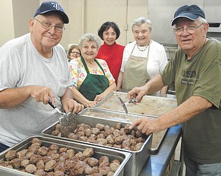 In preparation for St. Patrick Church spaghetti dinners, “the holy rollers” prepare meatballs. From left are Tom Price, Bernadette Nickelson, Ann Lawson, Carlotta Kane, Alice Noga and Ed Kocur.