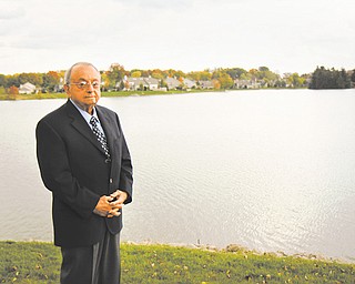 Philanthropist Dr. Dominic Bitonte stands in front of the lake in the backyard of his home in Columbiana.