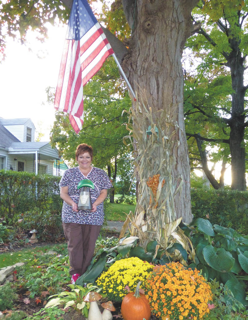 Kelly Ruble, of Scheetz Street, holds the Volney Rodgers Emerald Pierogi Trophy that she and her husband, Kent, won as the grand champions in the Rocky Ridge Neighborhood Association competition that recognizes efforts of home and lawn beautification. Other finalists were Milan and Donna Zordich of South Hazelwood Avenue, Sharon and Dave Jackson of Birch Hill, Chris and Jamie Romeo of Birch Hill and Pat Sedwick of Chaney Circle. 