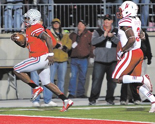 Ohio State quarterback Braxton Miller, left, scores a touchdown against Nebraska safety Daimion Staff ord during the second quarter of an NCAA game Saturday in Columbus. The Buckeyes won 63-38.