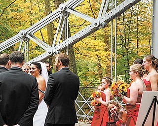 Julie Posey and Joshua Shaull, both of Cortland, were married Sunday on the silver Suspension Bridge in Mill Creek MetroParks. The couple chose the date and location so the natural scenery of autumn could serve as decoration.