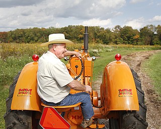 MADELYN P. HASTINGS | THE VINDICATOR
Dennie Unger, local farmer from Columbiana, drives the tractor pulling several people for a hay ride at the autumn fest.