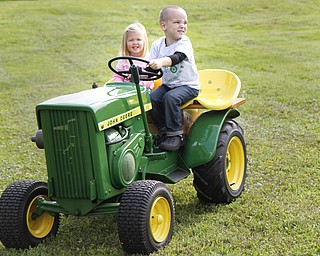 MADELYN P. HASTINGS | THE VINDICATOR

Audrey Booth, 2, and Kaden Phillis, 3, both of New Waterford rode a miniature tractor at the autumn festival.