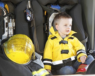 MADELYN P. HASTINGS | THE VINDICATOR
Landon Lovey, 2, of Hubbard, Ohio tests out a fire truck at the Hubbard fire open house while wearing his fire fighting jacket and boots. His father and grandfather are both firefighters.