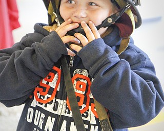 MADELYN P. HASTINGS | THE VINDICATOR

Justin Bish, 5, from Hubbard, Ohio wears his uncle's firefighting helmet at the Hubbard fire open house on October 11, 2012.