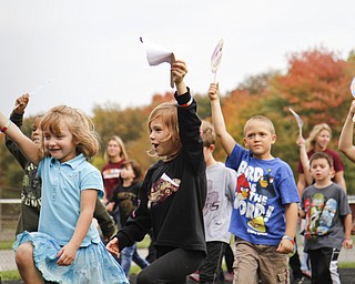 MADELYN P. HASTINGS | THE VINDICATOR
Students at EJ Blott Elementary walk the track of the Liberty Football field holding their decorated smiles during Smile Day. Smile Day was held to raise money for cleft palate surgeries of children in the area. One surgery costs $250 and the school raised $369.15 by collecting loose change from students and faculty.
