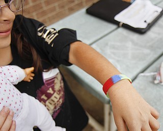 MADELYN P. HASTINGS | THE VINDICATOR
Carolynn Armstrong, 8, shows off her Smile Train bracelet during Smile Day at EJ Blott Elementary. Smile Train is a non-profit organization that arranges programs worldwide such as Smile Day. Smile Day was held to raise money for cleft palate surgeries of children in the area. One surgery costs $250 and the school raised $369.15 by collecting loose change from students and faculty. Carolynn recently received the surgery.