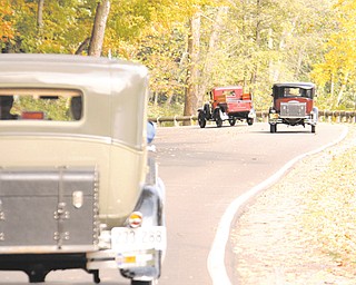 These Model A Fords wind their way through Mill Creek Park as part of the Penn-Ohio Model A Ford Club’s fall foliage tour through the park.
