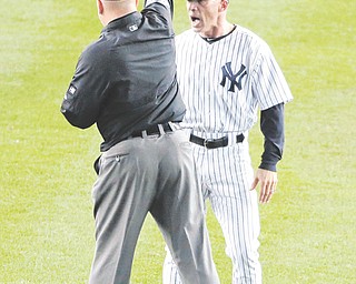 Yankees manager Joe Girardi is ejected by umpire Jeff Nelson after an argument over a missed call on a two out
play against Detroit in the eighth inning of Game 2 of the American League Championship Series on Sunday in New York. The Tigers won 3-0 to take a two game lead in the series.