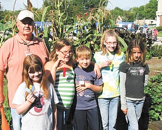 David Causer, educator, is shown with children in the youth garden program sponsored by the Men’s Garden Club of Youngstown. From left are Greta Graffius, Alex Okelberry, Mike Wade, Katie McHugh and Daisy Gretsinger.