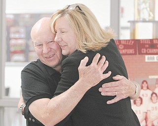 Struthers High basketball standout Bonnie Beachy receives a hug from her former coach, Dick Prest, during a visit to her alma mater Thursday. Beachy, who now lives in Texas, is battling cervical cancer for the second time with the intensity and fight that led her to a state championship (1978) and to being the Wildcats’ all-time scoring leader (1,448 points).
