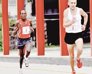 Matt Folk, front, a resident of Oregon, Ohio, collected $1,000 as the 10K winner of the 2009 Peace Race, while Elijah Nyabuti walked away from the awards table without a $500 check as runner-up because of a rule in which international runners must win in the open race or masters categories or go home empty. It’s something race founder Jack Cessna wants addressed.