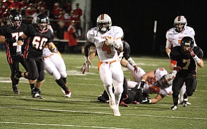NICK MAYS l THE VINDICATOR (4) De'Veon Smith of Howland breaks a long touchdown run during the second quarter Friday night in Canfield. howland vs canfield 10192012 Canfield, Ohio