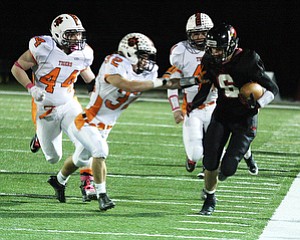 NICK MAYS l THE VINDICATOR (6) Nate Rusu of Canfield heads down the side line as (32) Jordan Radrich, (44) Daniel Cash and (41) Ralph Robinson give chase during the first quarter Friday night in Canfield. howland vs canfield 10192012 Canfield, Ohio