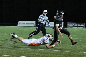 NICK MAYS l THE VINDICATOR (9) Kimu Kim of Canfield escapes the tackle attempt of (5) Brendan Cope of Howland during the first quarter Friday night in Canfield. howland vs canfield 10192012 Canfield, Ohio