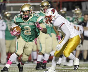 ROBERT K. YOSAY | THE VINDICATOR..#2 Ursuline Tramain Thigpen breaks out of the backfield as he breezes by #7 Mooney Marlan Everson during third quarter action -..Mooney @ Ursuline YSU Stadium - Ursuline won 44-24 -... - -30-..