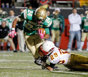 ROBERT K. YOSAY | THE VINDICATOR..Stopping #24 Jermaine Williams is Mooneys #29 Joe Kleeh.. as he got a first down during secon quarter aciton .Mooney @ Ursuline YSU Stadium - Ursuline won 44-24 -... - -30-..