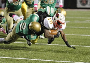 ROBERT K. YOSAY | THE VINDICATOR..All wrapped up Mooney #10 Justus Ellis Moore is brought down by two Ursuline defenders during first quarter action #6 Shannon Hightower and #26 Macus Mosley - ..Mooney @ Ursuline YSU Stadium - Ursuline won 44-24 -... - -30-..