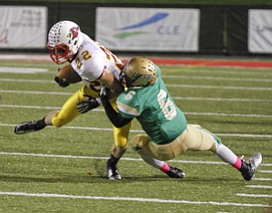 ROBERT K. YOSAY | THE VINDICATOR..Ursulines #6 Shannon Hightower brings down #22 Mooney Mark Handel after getting a first down in first quarter action at YSU..Mooney @ Ursuline YSU Stadium - Ursuline won 44-24 -... - -30-..