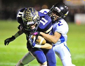 Youngstown Christian's #2 Darien Townsend hangs on to Brookfield receiver #11 Collin Harkulich after a reception.