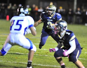 Brookfield running back #3 Ryan Masora looks for a block from receiver #1 Joe Clark on Youngstown Christian's #15 Robert Thompson.