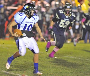 Youngtsown Christian quarterback #10 Emmett Underwood scrambles for a first down on a quarterback draw.