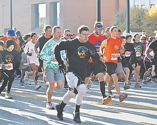 Runners in the 2-mile event of the Youngstown Peace Race dart through downtown Youngstown. The race Sunday attracted a record number of participants.